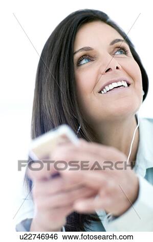 Stock Photograph - Woman listening to music. Fotosearch