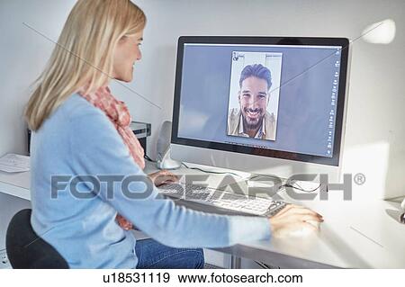 Woman making desktop video call to boyfriend View Large Photo Image Stock Photo - Woman making desktop video call to boyfriend. Fotosearch