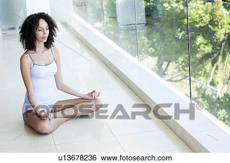 Stock Photograph - Woman meditating. Fotosearch