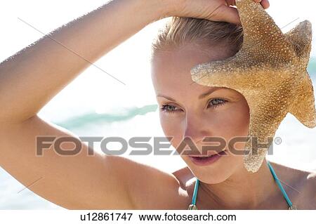 Stock Photo - Woman on a beach. Fotosearch