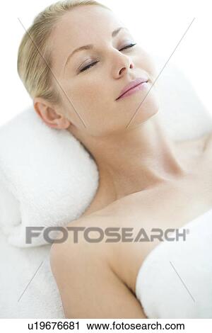 Stock Image - Woman relaxing at a spa. Fotosearch