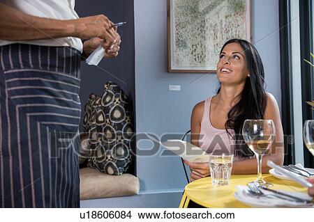 Woman speaking to waiter in restaurant View Large Photo Image Picture - Woman speaking to waiter in restaurant. Fotosearch