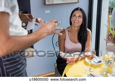 Woman speaking to waiter in restaurant View Large Photo Image Stock Image - Woman speaking to waiter in restaurant. Fotosearch