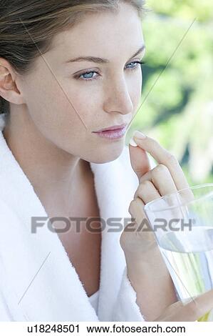 Woman taking painkillers View Large Photo Image Stock Image - Woman taking painkillers. Fotosearch