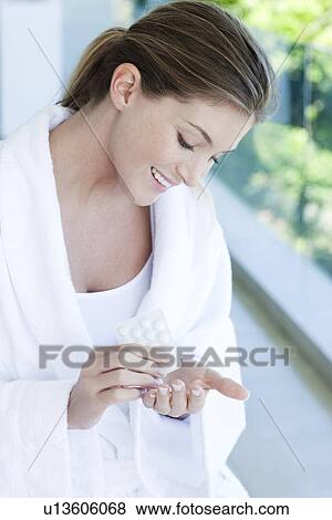 Woman taking painkillers View Large Photo Image Stock Photo - Woman taking painkillers. Fotosearch