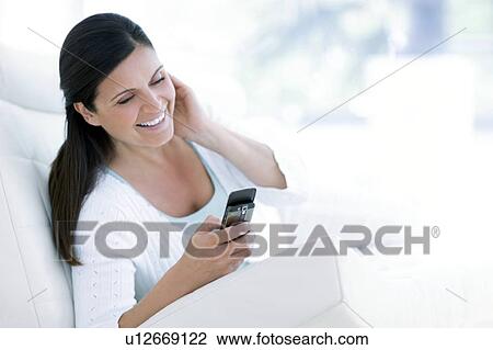 Stock Image - Woman texting. Fotosearch