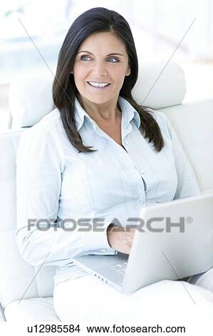 Woman using a laptop View Large Photo Image Picture - Woman using a laptop. Fotosearch