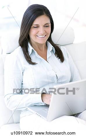 Woman using a laptop View Large Photo Image Stock Image - Woman using a laptop. Fotosearch