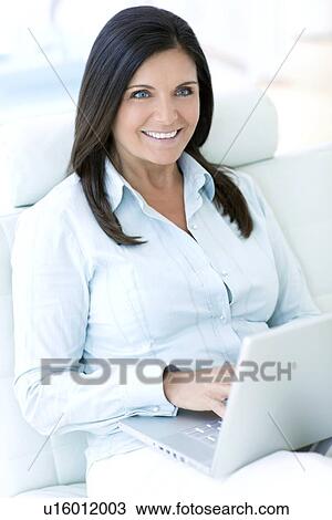 Woman using a laptop View Large Photo Image Stock Image - Woman using a laptop. Fotosearch