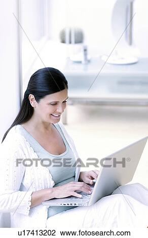 Stock Image - Woman using a laptop. Fotosearch