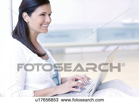 Woman using a laptop View Large Photo Image Stock Image - Woman using a laptop. Fotosearch