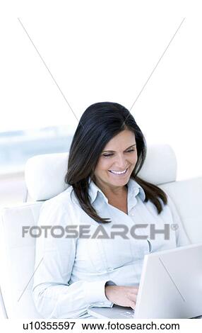 Stock Photo - Woman using a laptop. Fotosearch