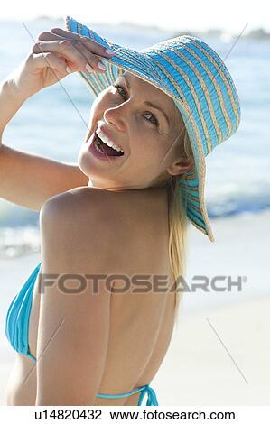 Stock Image - Woman wearing a sun hat. Fotosearch