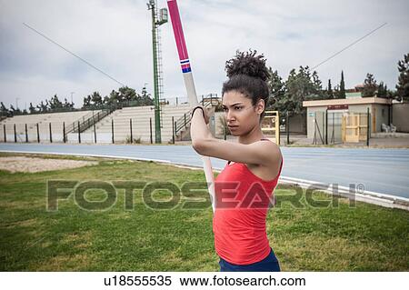 Young female pole vaulter concentrating at sport facility View Large Photo Image Stock Photography - Young female pole vaulter concentrating at sport facility. Fotosearch