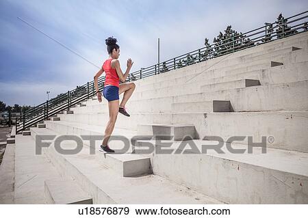 Young female runner training on stairway View Large Photo Image Stock Photo - Young female runner training on stairway. Fotosearch