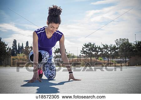 Young female sprinter on her marks at sport facility View Large Photo Image Stock Photography - Young female sprinter on her marks at sport facility. Fotosearch