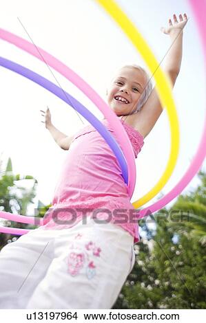 Young girl hula-hooping View Large Photo Image Picture - Young girl hula-hooping. Fotosearch
