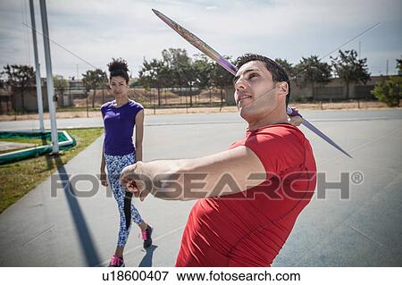 Young male javelin thrower practicing at sports ground View Large Photo Image Stock Photo - Young male javelin thrower practicing at sports ground. Fotosearch
