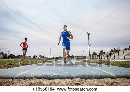 Young male long jumper sprint training at sport facility View Large Photo Image Picture - Young male long jumper sprint training at sport facility. Fotosearch
