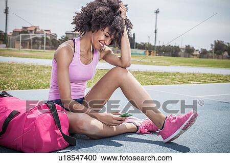 Young woman training, taking a break on running track View Large Photo Image Stock Image - Young woman training, taking a break on running track. Fotosearch