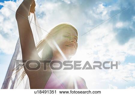 Young woman with scarf against sunlit blue sky, Miami Beach, Florida, USA View Large Photo Image Stock Image - Young woman with scarf against sunlit blue sky, Miami Beach, Florida, USA. Fotosearch