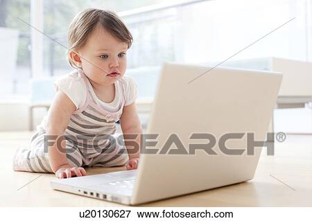 Stock Photo - Baby playing with a laptop. Fotosearch