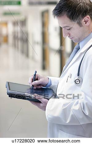 Doctor using a tablet PC View Large Photo Image Stock Image - Doctor using a tablet PC. Fotosearch