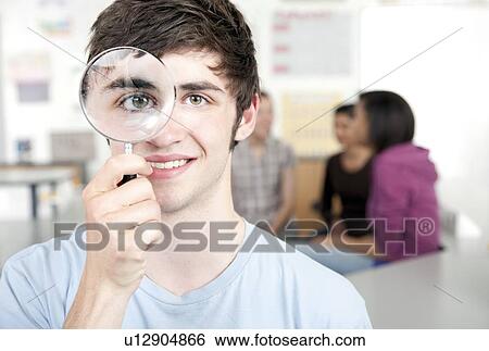 Teenage boy with magnifying glass View Large Photo Image Stock Photograph - Teenage boy with magnifying glass. Fotosearch