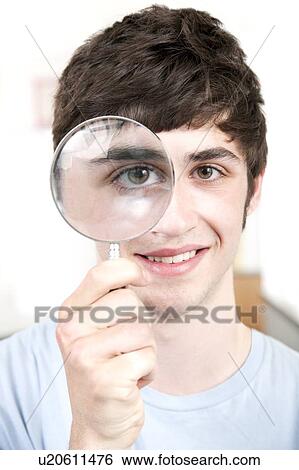Teenage boy with magnifying glass View Large Photo Image Stock Photograph - Teenage boy with magnifying glass. Fotosearch
