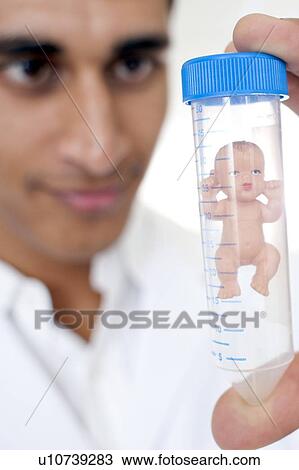 Stock Image - Test tube baby, conceptual image. Fotosearch