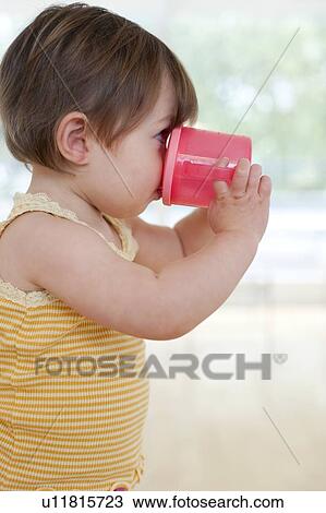 Stock Image - Toddler drinking. Fotosearch
