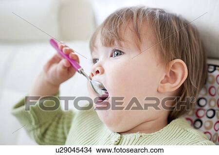 Picture - Toddler eating. Fotosearch