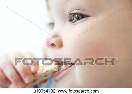 Stock Image - Toddler eating. Fotosearch