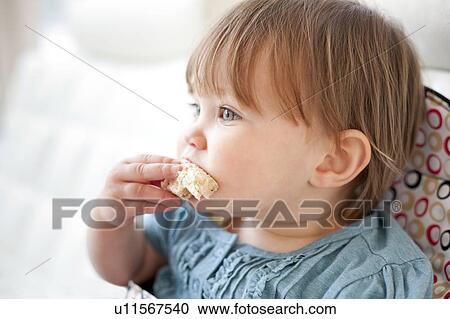 Toddler eating View Large Photo Image Stock Image - Toddler eating. Fotosearch