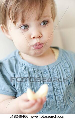 Toddler eating View Large Photo Image Stock Photograph - Toddler eating. Fotosearch