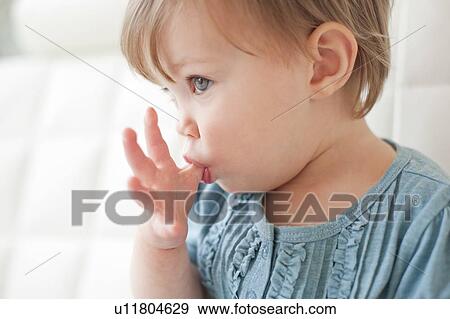 Stock Photo - Toddler sucking her thumb. Fotosearch