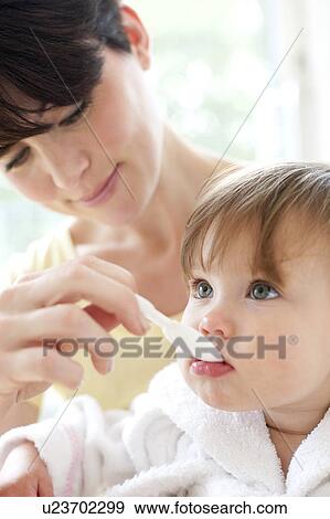 Stock Photo - Toddler taking medicine. Fotosearch
