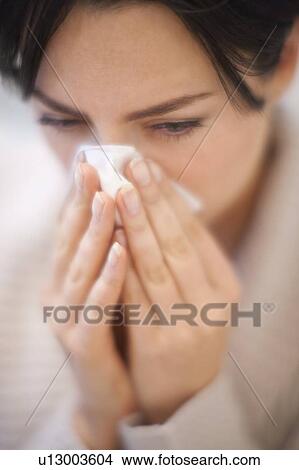 Woman blowing her nose View Large Photo Image Picture - Woman blowing her nose. Fotosearch