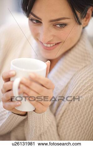 Stock Image - Woman drinking a hot drink. Fotosearch