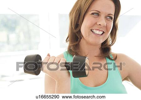 Stock Image - Woman lifting weights. Fotosearch