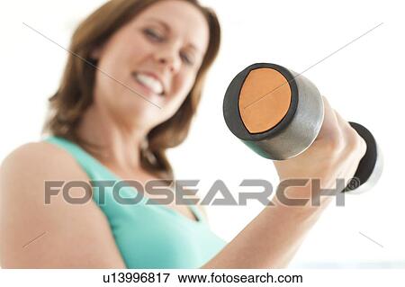 Stock Photo - Woman lifting weights. Fotosearch
