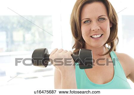 Woman lifting weights View Large Photo Image Stock Photo - Woman lifting weights. Fotosearch