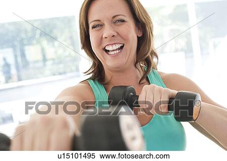 Stock Photography - Woman lifting weights. Fotosearch