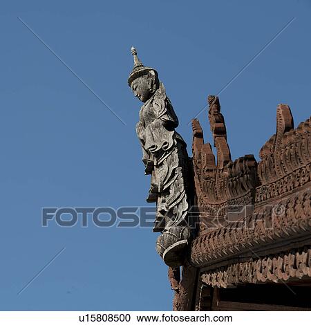 Stock Image - Apsara statue on the top of Mandarin Oriental Dhara Dhevi, Chiang Mai, Thailand. Fotosearch