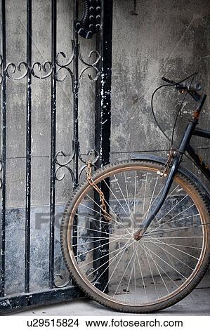 Bicycle locked at a gate, Shanghai, China View Large Photo Image Picture - Bicycle locked at a gate, Shanghai, China. Fotosearch