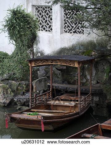 Stock Image - Boats in a canal in the Master of the Nets Garden, Suzhou, Jiangsu Province, China. Fotosearch