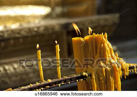 Stock Photograph - Burning candles in a Pra Thad Doi Suthep Pagoda temple, Wat Phrathat Doi Suthep, Chiang Mai, Thailand. Fotosearch