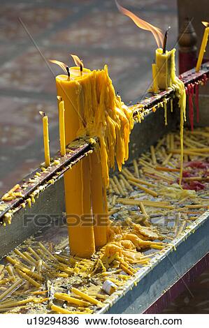 Stock Photograph - Candles burning at Wat Phrathat Doi Suthep, Chiang Mai, Thailand. Fotosearch