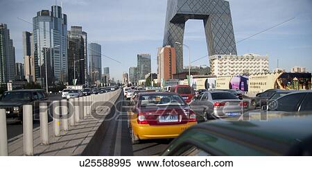 Stock Photography - Cars on the road, CCTV Headquarters, Beijing, China. Fotosearch