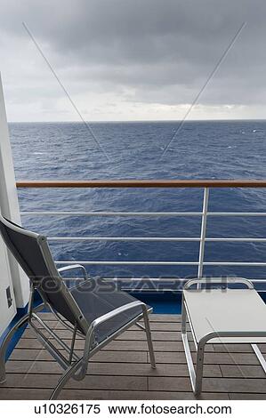 Stock Photography - Chair and a stool on the deck of cruise ship Silver Shadow, East China Sea. Fotosearch